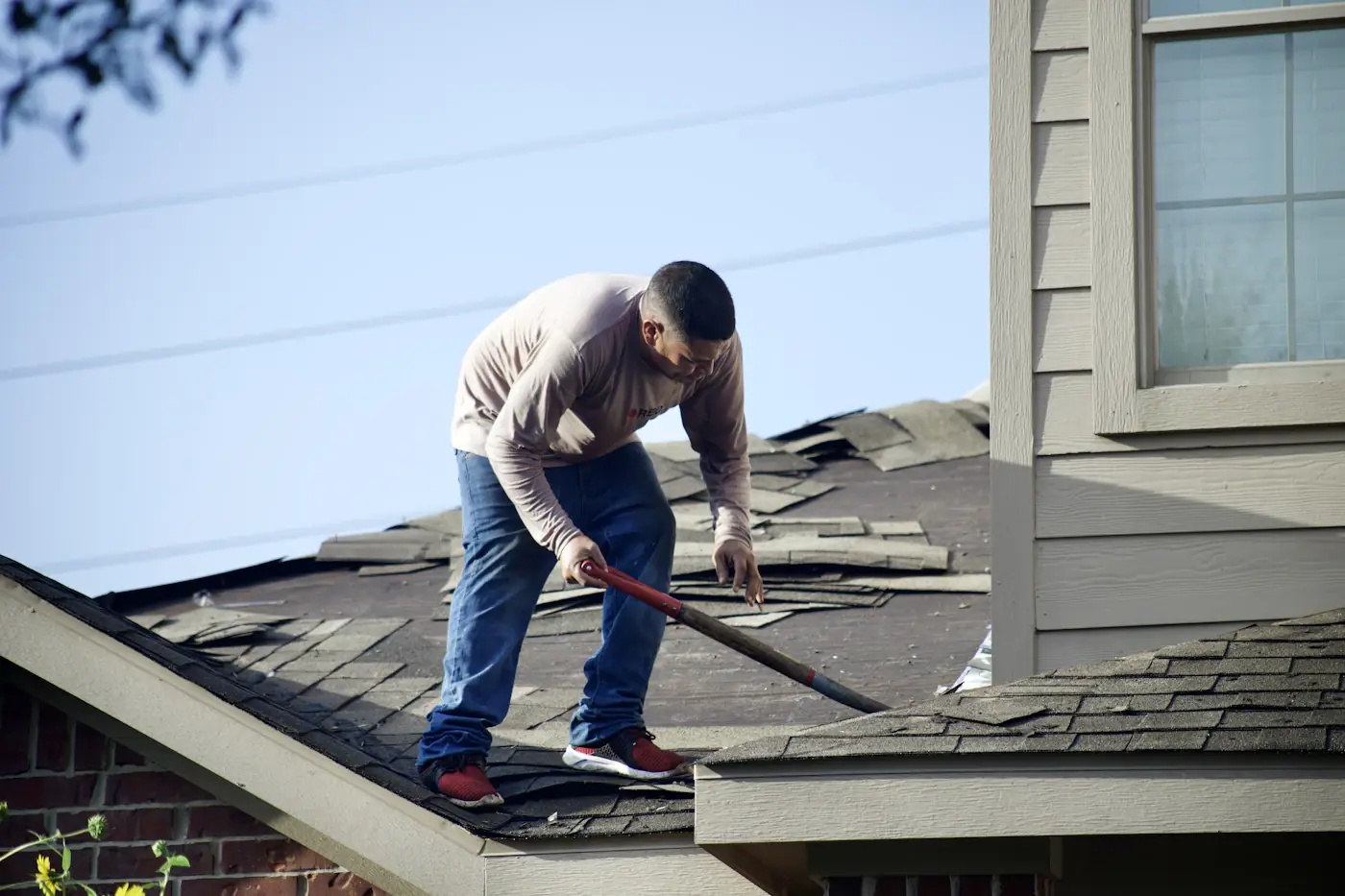 Roof shingle installation representing professional roofing services